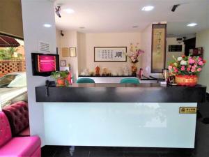 a restaurant with a counter with flowers on it at SENG WAH HOTEL in Singapore