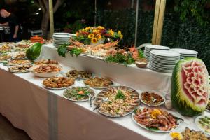 a buffet of food on a table with plates of food at Hotel La Collinetta in Morciano di Leuca