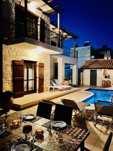 a patio with a table and chairs and a pool at Villa Darmarohori Homeleader in Darmarochori