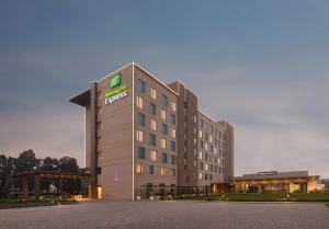a hotel building with a sign on the front of it at Holiday Inn Express Kolkata Airport by IHG in Kolkata