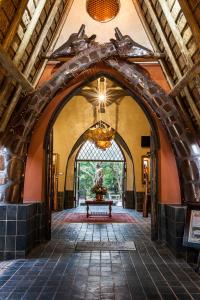 an archway in a building with a statue in it at Misty Hills Country Hotel, Conference Centre & Spa in Muldersdrift