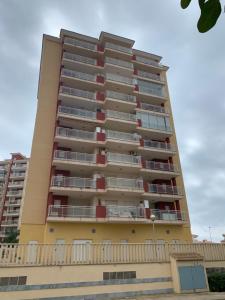 a tall yellow apartment building with red balconies at Napoles LMPRC 014 in San Blas +4 photos