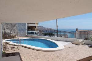 a swimming pool with a view of the ocean at Apartamento Calypso in Peniscola