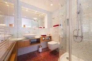 a bathroom with a sink and a toilet and a shower at Rosa Linde - Comfort Rooms in Vienna