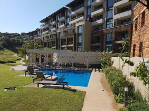 a swimming pool in front of a building at Zimbali Suite 112 in Ballito