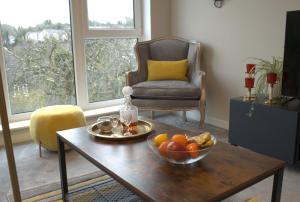 a living room with a bowl of fruit on a table at The Copper Pan by Ritual Stays in Hemel Hempstead