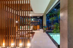a lobby of a house with a swimming pool at Omah Sabin Villa East in Canggu