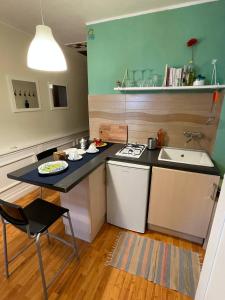 a small kitchen with a table and a sink at Appartamento Taormina vista mare in Taormina