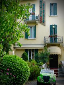 a green car parked in front of a building at Hotel Giglio in Salsomaggiore Terme