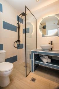 a bathroom with a toilet and a sink and a mirror at Faliraki Premium Hotel in Faliraki