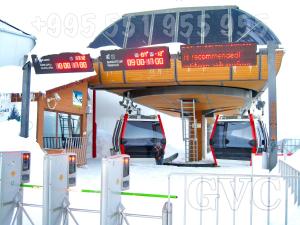 a bus stop with two cars parked in the snow at GVC 4-room 421 New Gudauri in Gudauri