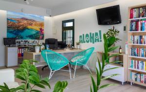 an office with a desk and two blue chairs at Apartamentos La Tegala in Puerto del Carmen