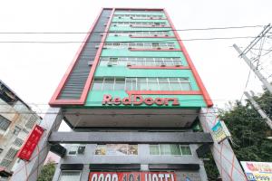 een hoog gebouw met een rood wagentje erop bij RedDoorz near Quiapo Church Manila in Manilla