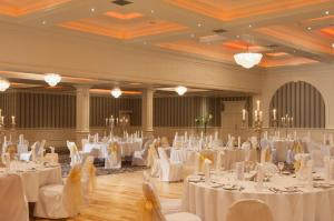 a banquet hall with white tables and chairs at Clanree Hotel & Leisure Centre in Letterkenny
