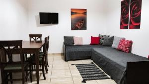 a living room with a couch and a table at Kallisti Apartments in Skiathos