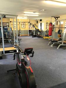 a gym with several treadmills and exercise bikes at Auburn Lodge Hotel & Leisure Centre in Ennis