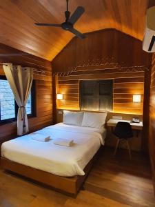 a bedroom with a large bed and a desk at PAN KLED VILLA eco hill resort - SHA extra plus in Chiang Rai
