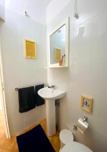 a bathroom with a sink and a toilet and a mirror at Ca' Santa Barbara, Free Wi-fi, Sea view, Sal Rei, Boa Vista, Cape Verde in Sal Rei