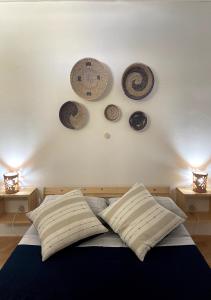 a bedroom with a bed with plates on the wall at Ca' Santa Barbara, Free Wi-fi, Sea view, Sal Rei, Boa Vista, Cape Verde in Sal Rei