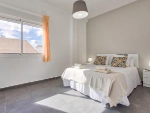 Łóżko lub łóżka w pokoju w obiekcie Sur Suites El Carmen