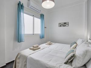 Łóżko lub łóżka w pokoju w obiekcie Sur Suites El Carmen