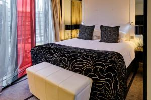 a hotel room with a bed with a black and white blanket at Crowne Plaza Manchester City Centre, an IHG Hotel in Manchester
