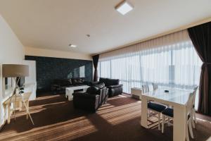 a living room with a couch and a table at Hotel Brcko Gas Prijedor in Prijedor