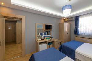 a hotel room with a bed and a desk at Hotel Yesilpark in Istanbul
