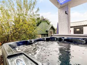 a pool of water in front of a house at Golden Crown exclusive use spa venue in Tarbolton