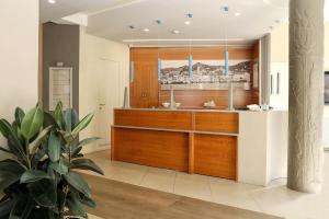a kitchen with wooden cabinets and a potted plant at Hotel Villa Igea Mhotelsgroup in Diano Marina +98 photos
