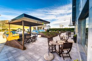 a patio with tables and chairs and a tent at Hotel Ruta Romana in Sagunto