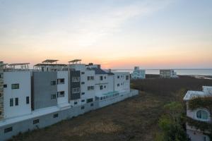 an apartment building with the sunset in the background at 鴻滿億民宿 in Magong
