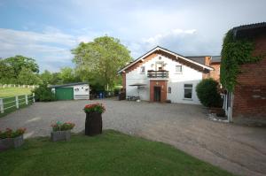 ein Haus mit Kieseinfahrt davor in der Unterkunft Pension Pohnsdorfer Mühle in Sierksdorf