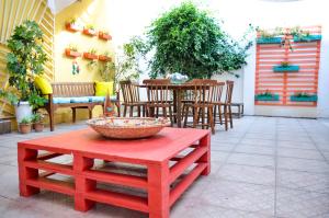 a red table and chairs on a patio at Casa da Adriana Pousada in Fortaleza