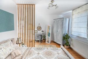 a bedroom with a bed and a large window at Casa Santa in Sighişoara