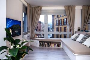 a living room with a couch and a large window at Downtown Como-Luxury Suites in Como