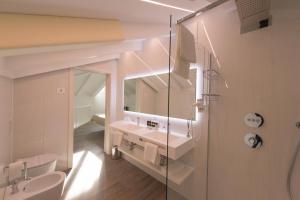 a bathroom with a sink and a mirror at Grand Hotel Liberty in Riva del Garda