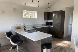 a kitchen with a large island in the middle at The Gallafield, Self Catering Bungalow , Stornoway in Stornoway