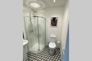 a bathroom with a shower and a toilet and a sink at The Gallafield, Self Catering Bungalow , Stornoway in Stornoway