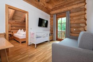 a baby room with a crib and a window at Apartment Bad Kleinkirchheim - 24 Chalet direkt an der Piste mit Outdoor Sauna in Bad Kleinkirchheim