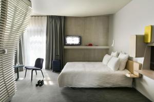 เตียงในห้องที่ Okko Hotels Strasbourg Centre