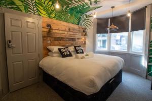 a bedroom with a bed with a wooden wall at Blok-74 in Brighton & Hove