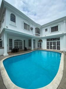 a swimming pool in front of a house at WHITE HOUSE in Guayaquil