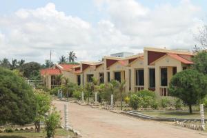 a row of houses on a dirt road at Resort Hirak Jayanti in Mandarmoni