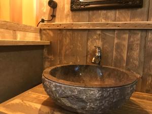 a bathroom with a large stone sink with a faucet at AZUR Camping Altmühltal in Kipfenberg