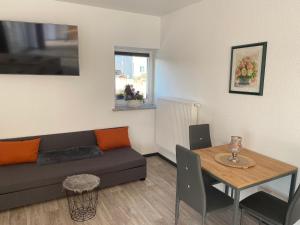 a living room with a couch and a table at Apartmenthaus Krone Wohnen mit Herz in Bexbach