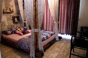 a bedroom with a bed with curtains on it at AKİDE BUTİK PANSİYON in Mudanya