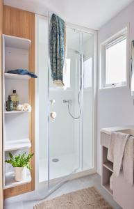 a bathroom with a shower with a glass door at Camping Du Paquier Fané in Chagny