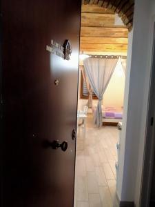 a door leading into a room with a bedroom at Il Loft nel Borgo Sospeso "con vista panoramica" in Vitorchiano
