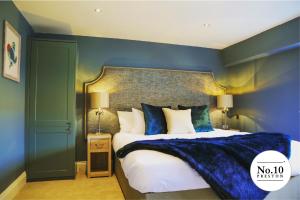 a bedroom with a king sized bed with blue walls at No.10 Preston in Preston
